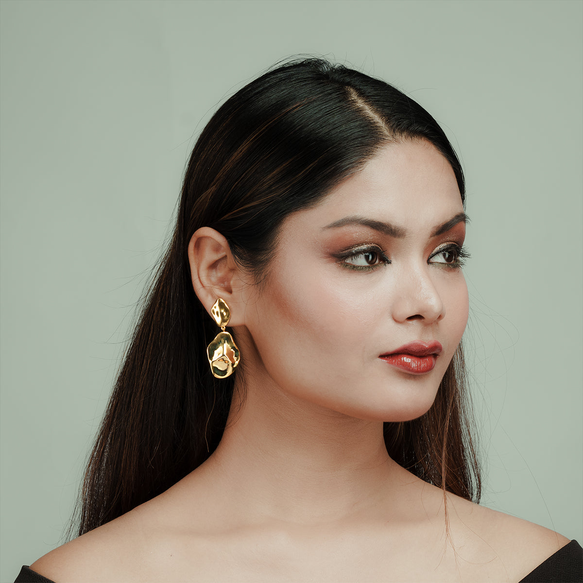 Woman wearing Gulban 18k gold-plated statement earrings – bold, modern demi-fine jewelry perfect for styling and gifting