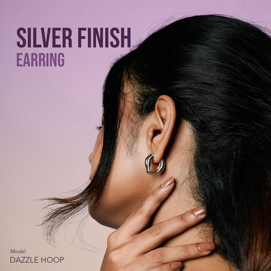 Close-up of Gulban’s Dazzle Hoop silver earring, a sculptural demi fine jewellery piece designed for modern elegance, crafted in 18k gold plated hypoallergenic material with a polished silver finish