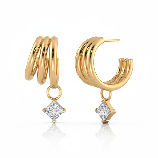 Gold hoop earrings with diamond-like pendants on a white background