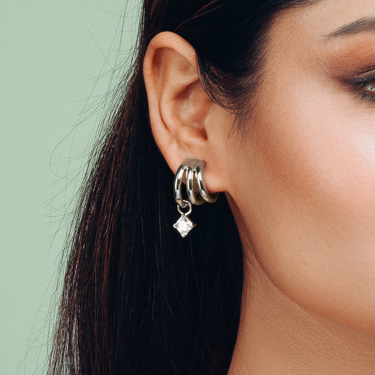 Close-up view of Hyperbola Silver Hoop Earring by Gulban featuring dual hoops and a solitaire drop, finished in 18K gold plating. A minimalist demi fine jewellery piece for elevated daily wear.