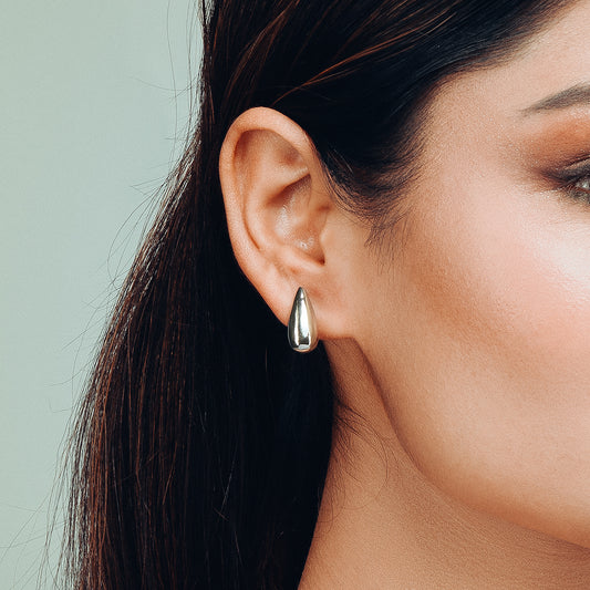 Close-up view of Tearlight Drop earring by Gulban, a modern, minimal silver teardrop-shaped design in demi fine jewellery, perfect for everyday elegance.