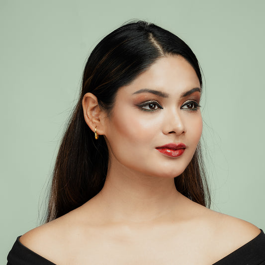 Front view of model wearing Gulban 18k gold-plated mini hoop earrings – elegant, lightweight everyday jewelry for women